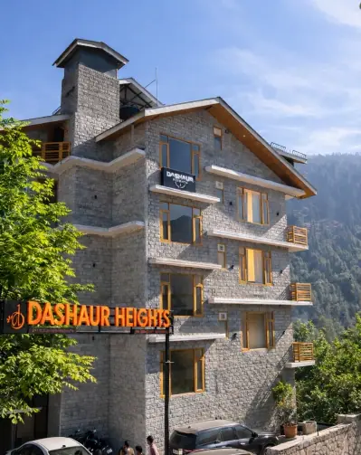 Dashaur Heights hotel building in Burwa, Manali with pine trees